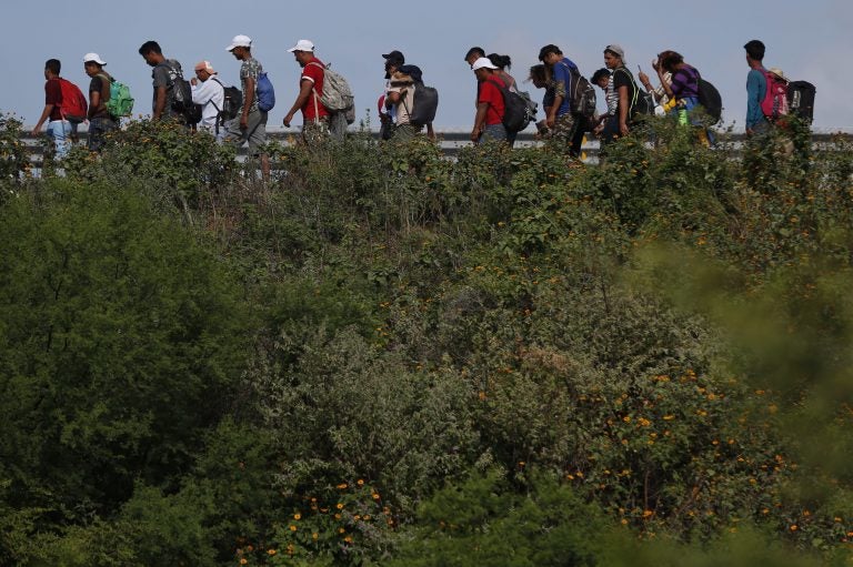 Migrants walk along the highway as part of a thousands-strong caravan of Central Americans continuing its slow journey toward the U.S. border, between Niltepec and Juchitan, Oaxaca state, Mexico, Tuesday, Oct. 30, 2018. (Rebecca Blackwell/AP Photo)