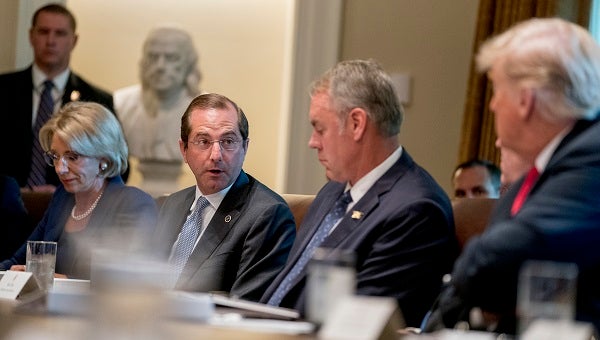 Health and Human Services Secretary Alex Azar, (center), accompanied by Education Secretary Betsy DeVos, (left), Interior Secretary Ryan Zinke, (right), and President Donald Trump, (right), speaks during a cabinet meeting in the Cabinet Room of the White House, Thursday, Aug. 16, 2018, in Washington. (Andrew Harnik/AP Photo)