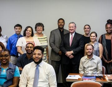 Mayor Jim Kenney poses with staff from community schools. (Brad Larrison for WHYY, file)