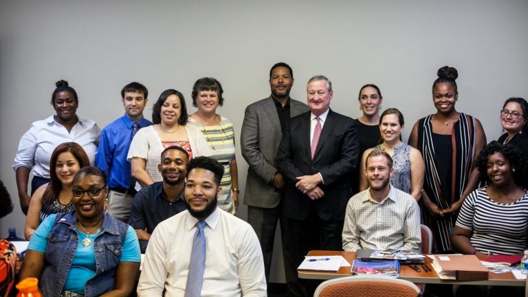 Mayor Jim Kenney poses with staff from community schools. (Brad Larrison for WHYY, file)