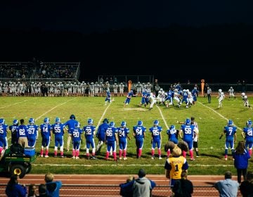 A player running the ball during the Kennard-Dale homecoming football game. (Dani Fresh for WHYY)