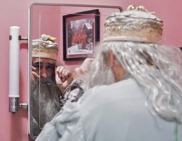 Walt Maguire adjusts his glasses in his bathroom mirror on October 20, 2017. Maguire, 60, played the part of Dumbledore at Chestnut Hill’s Harry Potter Festival for six years. Now, he is co-hosting the Witches and Wizards festival costume contest. (Rachel Wisniewski for WHYY)