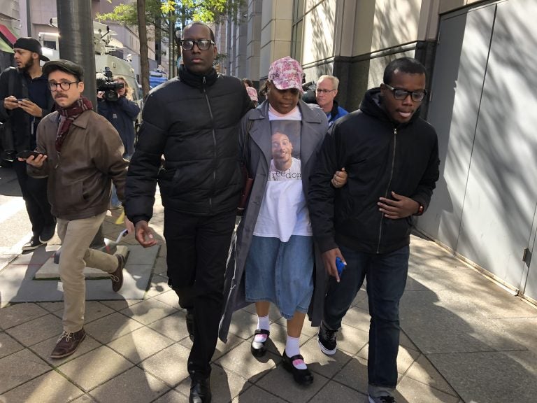 Michael White’s aunt leaves the Philadelphia courthouse Tuesday with activist Asa Khalif and family. Her nephew is facing third-degree murder charges in the stabbing death of Sean Schellenger in July. (Bobby Allyn/WHYY)