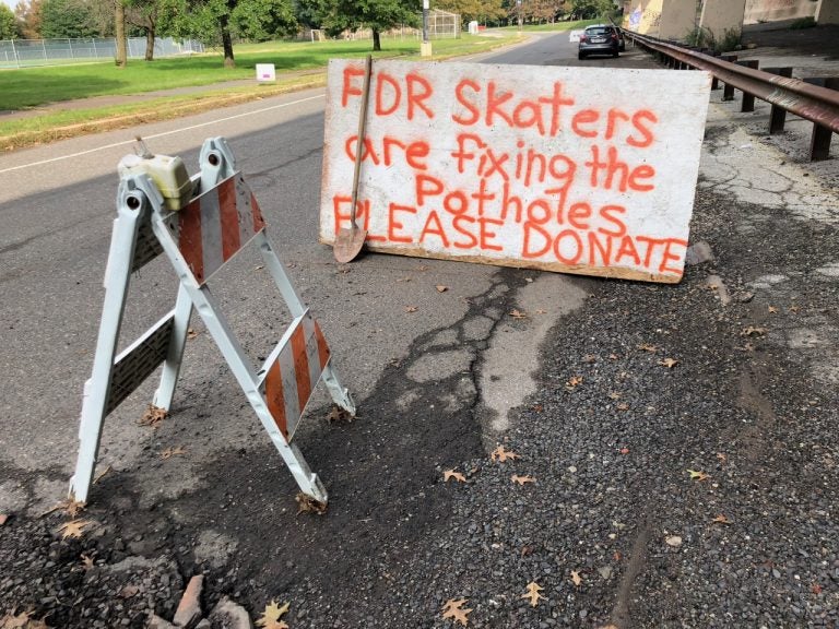 Skaters from FDR Skatepark set up a sign and 