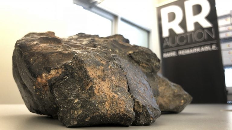 A 12-pound lunar meteorite discovered in Northwest Africa in 2017 rests on a table, in Amherst, N.H. (Rodrique Ngowi/AP)