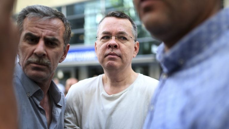 Andrew Brunson, seen here in July, arrives at his house flanked by Turkish officials in Izmir, Turkey. The newly freed U.S. pastor arrived Saturday on American soil, and he is meeting President Trump at the White House. (Emre Tazegul/AP)