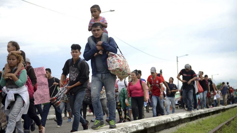 Thousands of Honduran migrants and families walk towards the southern Mexico border from Guatemala. Many say they are headed to the U.S. The White House said on Tuesday that a record number of migrant families have arrived at the Southwest border over the last year. (Oliver de Roos/AP)