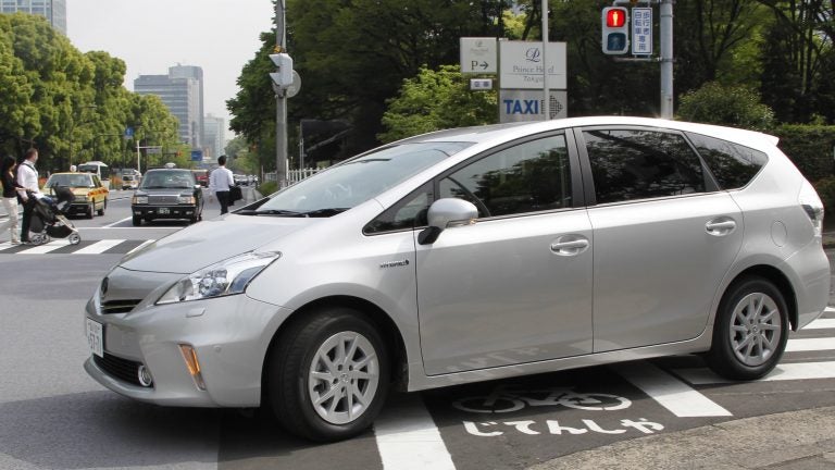 Toyota says it will use a software update to fix an issue with some Prius models, saying certain conditions could result in their unexpectedly stalling. Here, a Prius is seen during a test drive in Tokyo in 2011. (Koji Sasahara/AP)