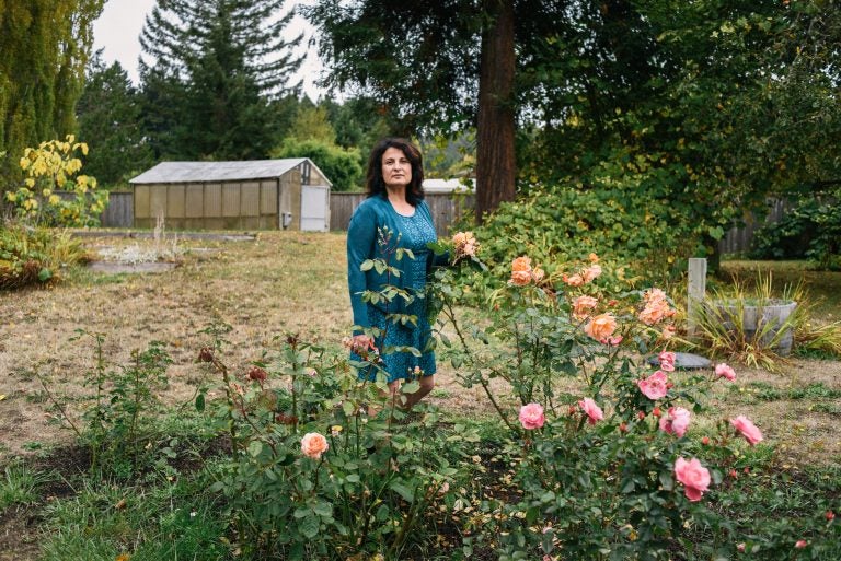 Janet Winston stands in her rose garden in Eureka, Calif. Testing revealed she is allergic to numerous substances, including linalool. Winston still can handle roses, which contain linalool, but she can't wear perfumes and cosmetic products that contain the compound.