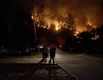 Residents watch as the 18,137 acre Holy Fire burns around them for the fourth day in Lake Elsinore, California in the early morning on August 10, 2018. (Photo by Christian Monterrosa / Sipa USA)(Sipa via AP Images)