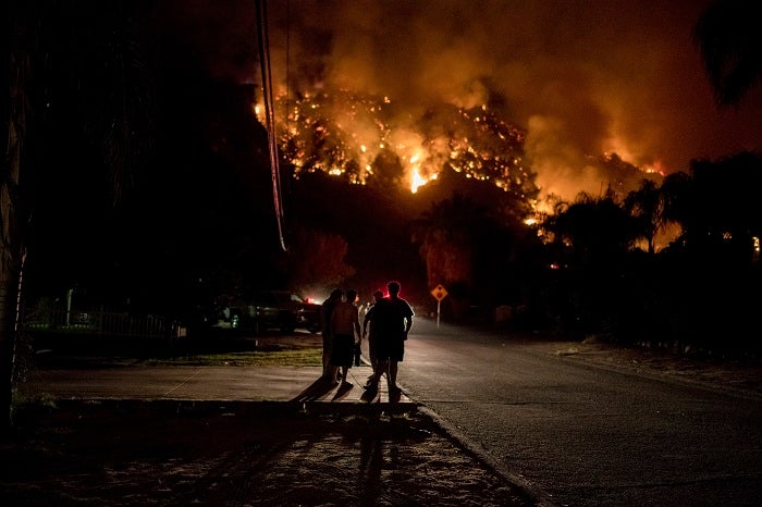 Residents watch as the 18,137 acre Holy Fire burns around them for the fourth day in Lake Elsinore, California in the early morning on August 10, 2018. (Photo by Christian Monterrosa / Sipa USA)(Sipa via AP Images)