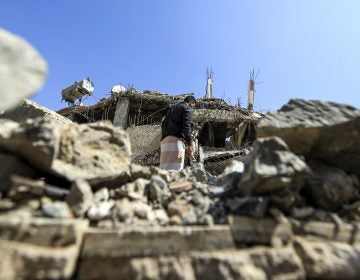 A Yemeni man walks through the rubble of a building after Saudi-led coalition airstrike last month in the capital, Sanaa. 