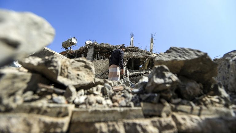 A Yemeni man walks through the rubble of a building after Saudi-led coalition airstrike last month in the capital, Sanaa. 