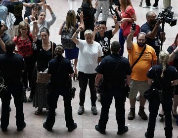 Activists chant during a protest outside the office of Senate Judiciary Committee Chairman Chuck Grassley of Iowa.