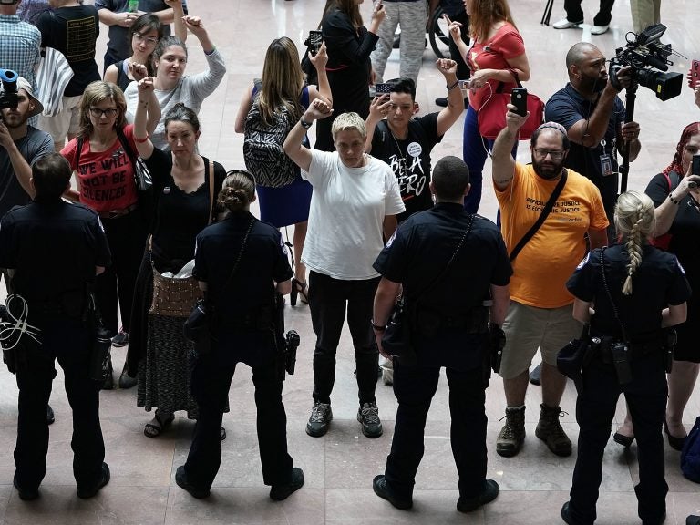 Activists chant during a protest outside the office of Senate Judiciary Committee Chairman Chuck Grassley of Iowa.