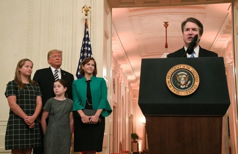 Newly sworn-in Supreme Court Justice Brett Kavanaugh speaks as his wife, daughters and President Trump listen on Monday. 