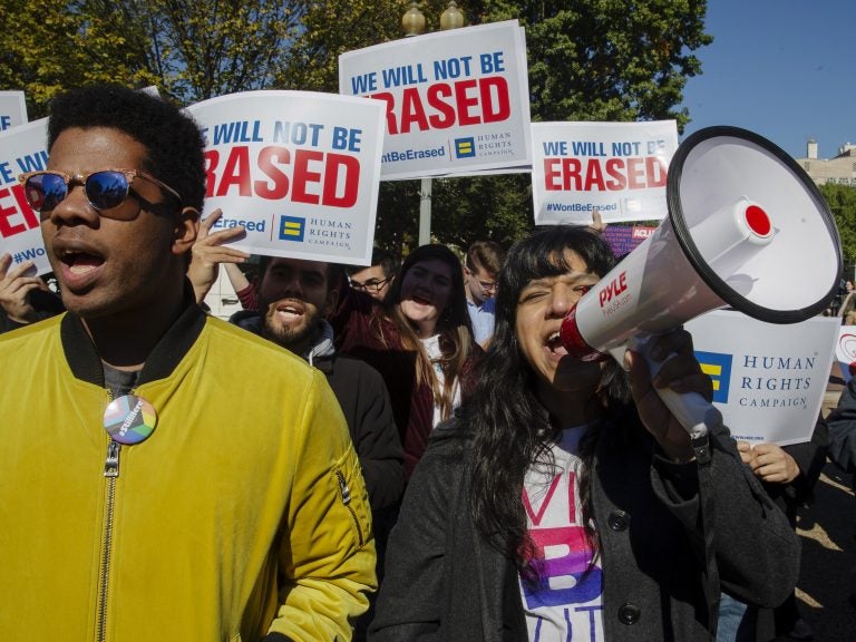 Demonstrators hold signs in support of trans equality outside the White House on Monday. The Trump administration is reportedly considering defining 