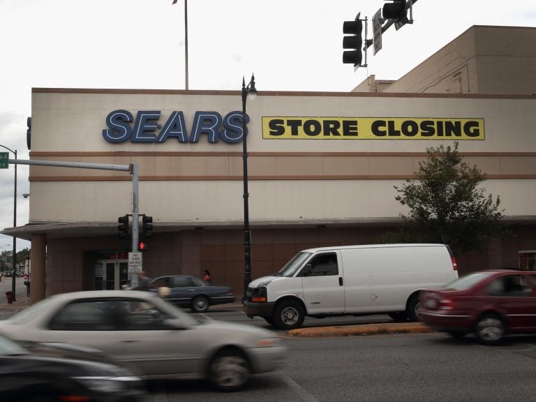 A sign announcing a store closing hangs above a Sears in Chicago. The bankruptcy filing could mark the end of the struggling retailer, which invented the mail-order catalog busines