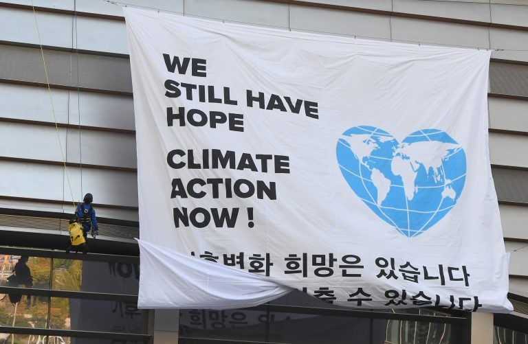 Greenpeace activists hang a banner prior to a press conference of the Intergovernmental Panel for Climate Change (IPCC) in Incheon, South Korea. The landmark U.N. report on limiting global warming to 1.5 degrees Celsius was released after a week-long meeting of the IPCC's 195 member nations.