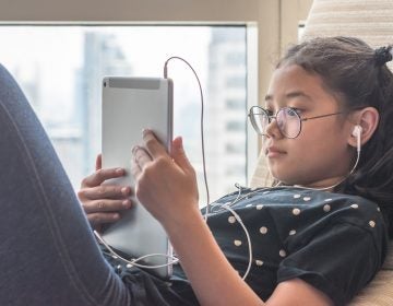 Digital technology lifestyle of school girl child or student using wireless internet for distance learning application and reading e-book app on mobile ipad smart device multimedia computer tablet