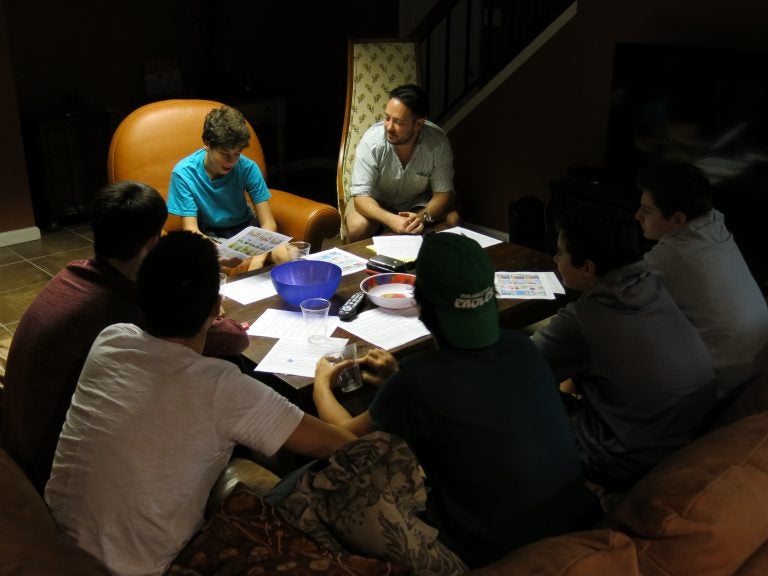 Cody Greenes (center), 35, group leader with the Jewish organization Moving Traditions, leads six high school freshman boys in a discussion about sexual assault and consent.