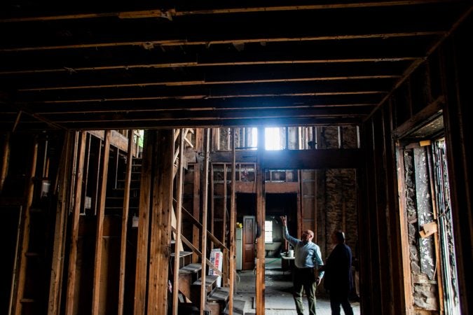 Tajar Domi and Bujar Gjoka of the Albanian American Association are seen inside of the historic Lower Dublin Academy in Northeast Philadelphia which they are working on restoring into an Albanian school and community center. (Brad Larrison for WHYY)