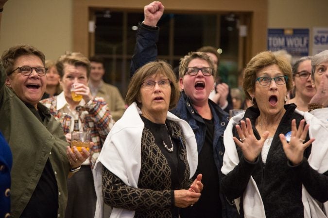 Frankie Franceschini, Linda McCarthy, Bonnie Shuman, and Sandy McCarthy (from left) react as results come in for the 2018 midterm elections November 6, 2018 in Swarthmore, Pa. (Emily Cohen for WHYY)