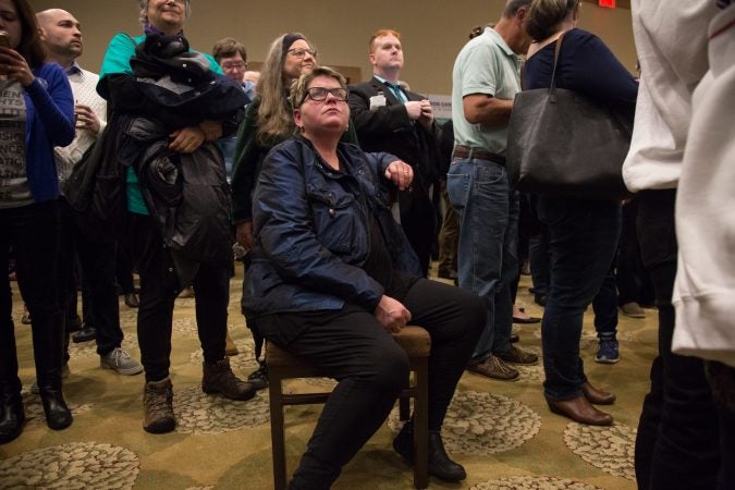 Bonnie Shuman, of Wayne, sits in her lucky blue coat as the results of the elections come in through a live stream. Hundreds of supporters came out to support various Pennsylvania Democratic candidates at the official watch party for Mary Gay Scanlon in Swarthmore, Pa. on November 6, 2018. (Emily Cohen for WHYY)