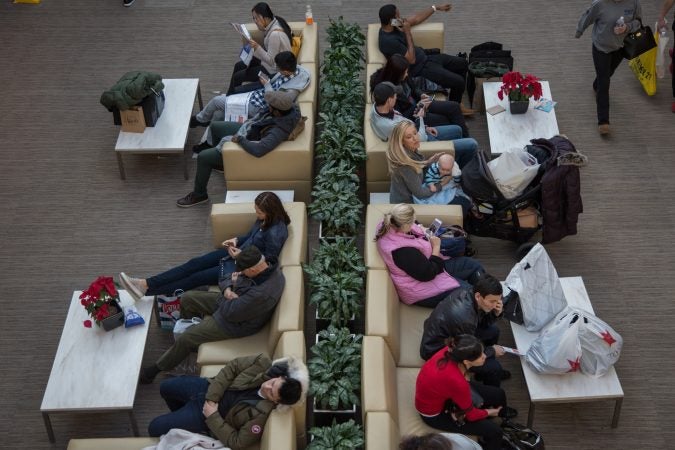 Shoppers take a break from the crowds and shopping on Black Friday at the King of Prussia Mall in Pennsylvania November 23rd 2018. (Emily Cohen for WHYY)