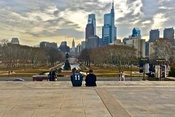 An Eagles fan takes in the city from the top of the steps to the Philadelphia Museum of Art, also known as the Rocky steps. (Emma Lee/WHYY)