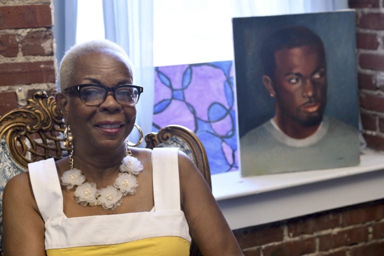 Dorothy Johnson-Speight, founder of Mothers in Charge, sitting before a painting of her murdered son, Khaliiq Jabbar Johnson. (Bastiaan Slabbers for Keystone Crossroads)