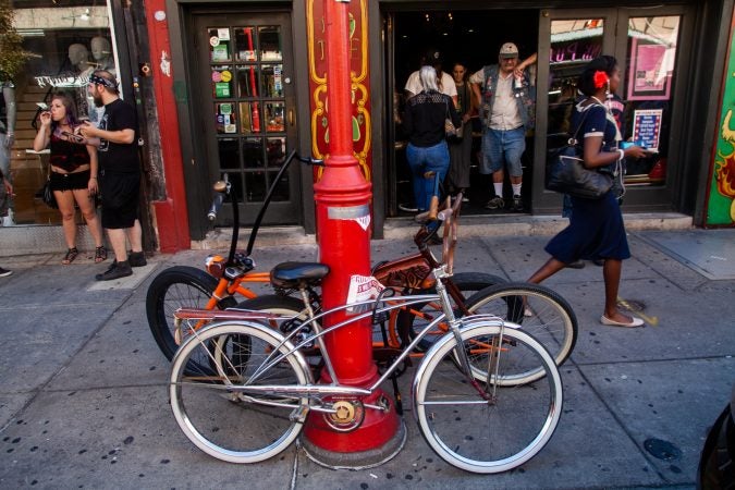 Some Jersey Devils keep a watchful eye on their rides outside of Tattooed Moms (Brad Larrison for WHYY)