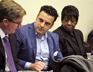 Developer Rahil Raza and Vivian VanStory consult with attorney Paul J. Toner during a Philadelphia zoning board meeting. (Emma Lee/WHYY)