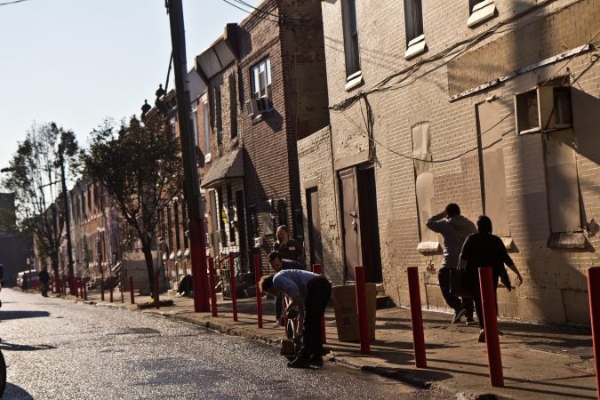 City workers and community groups work to clean up the streets of Kensington. (Kimberly Paynter/WHYY)