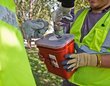 File photo: City workers and community groups work to clean up McPherson Square and the area around it, including disposing of used needles. (Kimberly Paynter/WHYY)