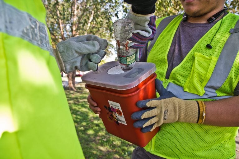 File photo: City workers and community groups work to clean up McPherson Square and the area around it, including disposing of used needles. (Kimberly Paynter/WHYY)