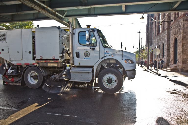 A street sweeper works along Kensington Avenue