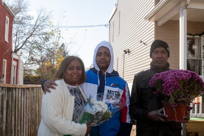 The Mella family outside of their home in the Tacony section of Philadelphia. (Brad Larrison for WHYY)