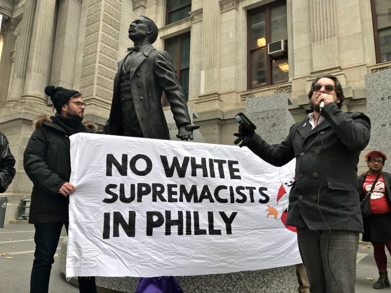 Ted Kelly of the Workers World Party (right) leads a protest against the We The People rally planned for Saturday on Independence Mall.