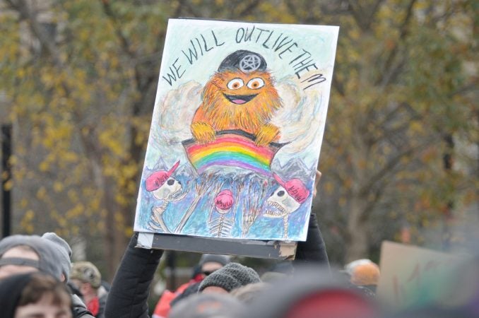 Gritty the Flyers mascot is found along a counter-protests facing the 