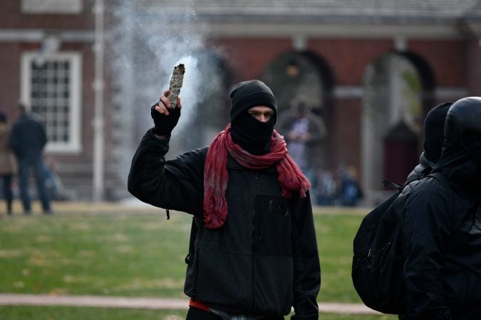 Smoke billows up from sage burned at a counter-protest facing the 