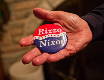 Frank Rizzo Jr. holds a campaign button with the Nixon/Rizzo ticket. (Kimberly Paynter/WHYY)