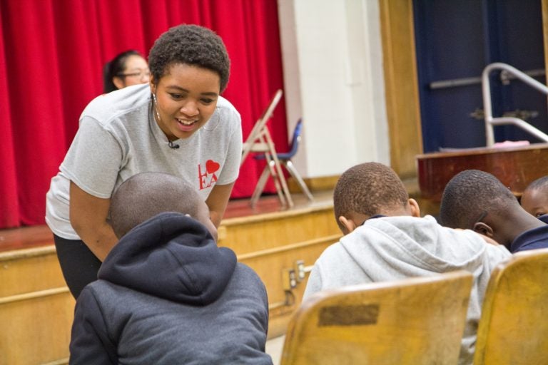 Anea Moore teaches choir to kids at Henry Lea Elementary school. The Philadelphia woman has won a Rhodes scholarship. (Kimberly Paynter/WHYY)