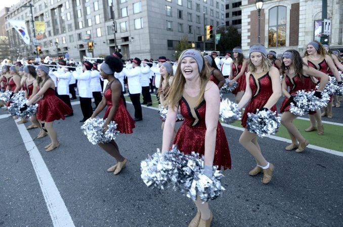 Cheerleaders and drum bands try to keep warm during the 99th annual Thanksgiving Day Parade, in Center City Philadelphia. (Bastiaan Slabbers for WHYY)