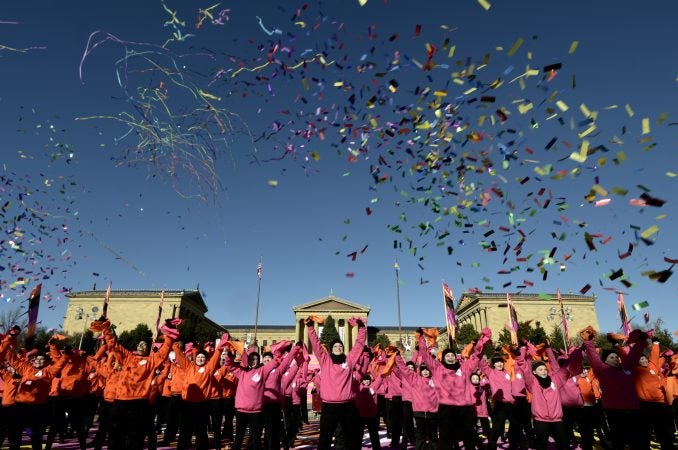 Streamers fill the sky in front of the Art Museum steps as performers take part in the televised component of the 99th annual Thanksgiving Day Parade. (Bastiaan Slabbers for WHYY)