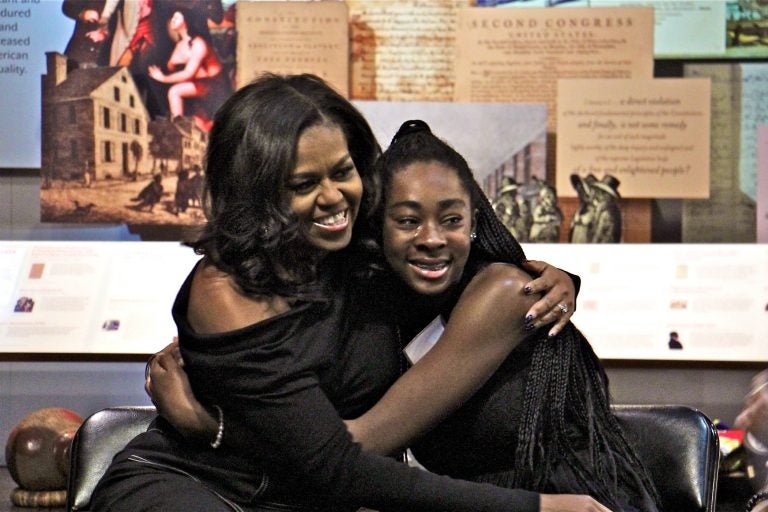 Michelle Obama embraces Nariah, a Philadelphia high school sophomore, during a surprise visit to the African American Museum in Philadelphia. A dozen girls in the beGirl.world program, which encourages African American girls to travel, were treated to an intimate question and answer session with the former First Lady.