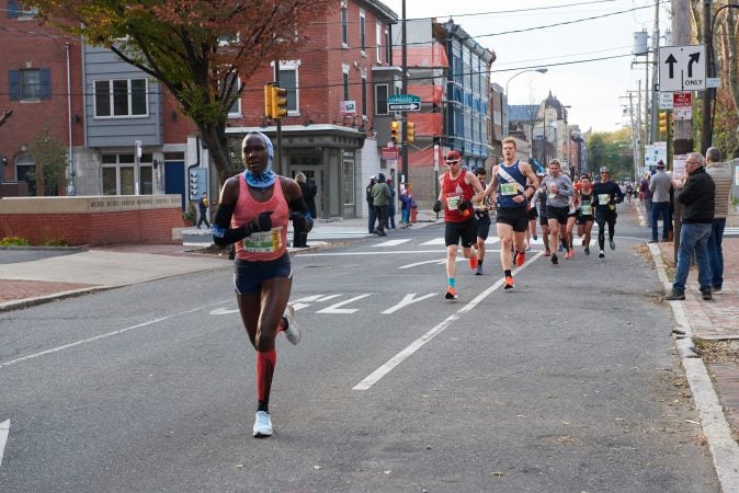 Participants of the 2018 Philadelphia Marathon run past Mother Bethel A.M.E. Church on Sixth street. (Natalie Piserchio for WHYY)