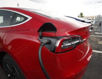 In this Sunday, July 8, 2018, photograph, 2018 Model 3 sedans charge while on display outside a Tesla showroom in Littleton, Colo. (David Zalubowski/AP Photo)