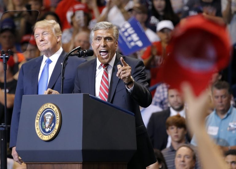 President Donald Trump listens to then-Senate candidate and U.S. Rep. Lou Barletta, R-Pa., speak during a rally, Thursday, Aug. 2, 2018, at Mohegan Sun Arena at Casey Plaza in Wilkes Barre, Pa. (AP Photo/Carolyn Kaster)