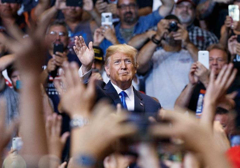 President Donald Trump waves to the cheering crowd as he arrives for a rally, Thursday, Aug. 2, 2018, at Mohegan Sun Arena at Casey Plaza in Wilkes Barre, Pa..